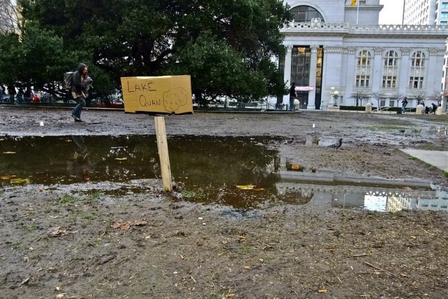 muddy area on Oscar Grant Plaza with a small sign that says Lake Quan